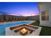 Inviting pool area featuring a fire pit, tanning deck, and elegant landscaping perfect for relaxation and entertaining at 11991 Rockview Point St, Las Vegas, NV 89138