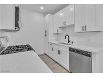 Modern kitchen featuring white cabinets, stainless steel appliances, and white countertops at 3318 N Decatur Blvd # 1035, Las Vegas, NV 89130