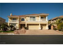 Stunning two-story home featuring a tile roof, dual balconies, and a three-car garage at 4384 Grey Spencer Dr, Las Vegas, NV 89141