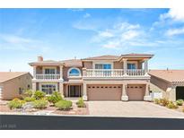 Elegant two-story home boasts dual balconies, a three-car garage, and manicured landscaping at 4542 Grey Spencer Dr, Las Vegas, NV 89141