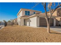 Charming two-story home with a desert landscape, a two-car garage, and a welcoming entrance, bathed in bright sunlight at 5357 Hammond Ct, Las Vegas, NV 89110