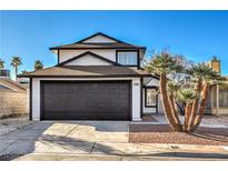 Charming two-story home showcasing a well-maintained front yard and a spacious two-car garage under a clear blue sky at 5825 Bent Branch Ln, Las Vegas, NV 89142