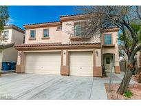 Beautiful two-story home showcasing a three car garage, desert landscaping, and a charming front entrance at 9824 Gallo Dr, Las Vegas, NV 89147