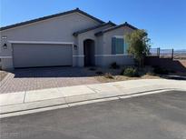 Charming single-story home featuring a neutral palette, low maintenance desert landscaping, and a two-car garage at 181 Sierra Alta Pl, Henderson, NV 89015