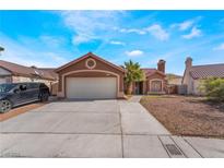 Charming single-story home featuring desert landscaping, a tile roof and an attached two-car garage at 4932 Goldeneye Way, North Las Vegas, NV 89031