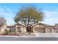 Charming single-story home featuring a well-maintained front yard with a desert landscape and a spacious three-car garage at 5968 Saint Lazare St, Las Vegas, NV 89130