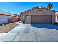 Charming single-story home featuring a well-maintained front yard and a two-car garage at 951 Carnival Ave, Las Vegas, NV 89123