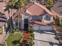 Elegant two-story home with a three-car garage, red tile roof, and palm tree landscaping at 2008 Arbor Forest St, Las Vegas, NV 89134