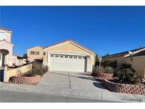 Charming single-story home featuring a two-car garage and desert landscaping at 2694 Hillgrass Rd, Las Vegas, NV 89123