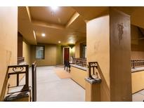 Mediterranean hallway showcasing beige walls, decorative railings, and sconce lighting at 30 Via Mantova # 202, Henderson, NV 89011