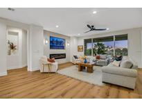 Bright living room with modern fireplace, large windows, and comfortable seating arrangement at 4718 Atlantico St, Las Vegas, NV 89135