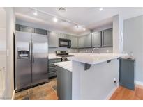 Well lit kitchen featuring stainless steel refrigerator, granite countertops, and updated appliances at 8452 Boseck Dr # 285, Las Vegas, NV 89145