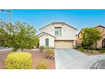 Inviting home featuring desert landscaping, attached two-car garage, and classic architecture at 11204 Newbury Hills Ave, Las Vegas, NV 89138