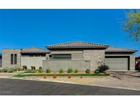 Modern single-story home featuring a manicured front yard and a three-car garage at 11296 Villa Bellagio Dr, Las Vegas, NV 89141