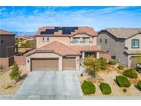 Charming two-story home featuring a three-car garage, landscaped front yard, and solar panels on the roof at 2176 De Narvik Dr, Henderson, NV 89044