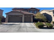 Inviting two-story home featuring a spacious three-car garage and a well-maintained front yard at 2176 De Narvik Dr, Henderson, NV 89044