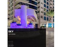 Striking condo building exterior with a circular water feature and vibrant blue architectural lighting at 2700 Las Vegas Blvd # 1604, Las Vegas, NV 89109