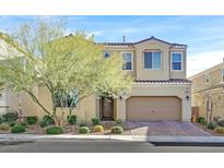 Charming two-story home featuring a well-manicured front yard, desert landscaping and a two-car garage at 3037 Villanelle Ave, Henderson, NV 89044