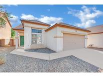 Charming single-story home featuring a two-car garage and well-maintained front yard landscaping at 3941 Yellow Mandarin Ave, North Las Vegas, NV 89081