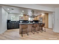 Modern kitchen boasts stainless steel appliances, a spacious island with bar seating, and sleek countertops at 4412 Denia Cir, Las Vegas, NV 89108