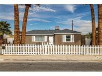 Charming single story home featuring a white picket fence and mature palm trees at 4606 Cory Pl, Las Vegas, NV 89107