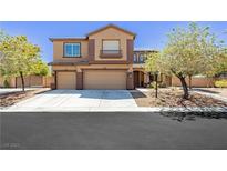 Two-story home featuring a large driveway, two-car garage, and well-manicured landscaping at 6391 Tempting Choice Ave, Las Vegas, NV 89131
