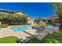 Inviting backyard pool area with lush landscaping and patio seating, perfect for outdoor relaxation and entertaining at 6391 Tempting Choice Ave, Las Vegas, NV 89131