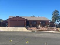 Charming single-story home with a two-car garage and desert landscaping at 706 Morrocco Dr, Henderson, NV 89002