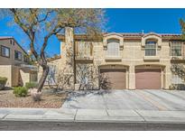 Inviting two-story home showcasing an attached two-car garage and manicured front yard at 7632 Amato Ave, Las Vegas, NV 89128