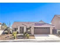 Charming single-story home showcasing a desert landscaped front yard and a two-car garage at 8745 Point Kathy Cir, Las Vegas, NV 89147