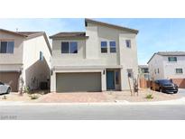 Two-story stucco home featuring a two-car garage, desert landscaping, and a modern design at 10246 Bloom Quick Ct, Las Vegas, NV 89141