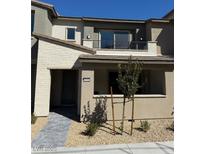 Charming two-story home featuring a balcony, neutral tones, and a well-maintained front yard with tasteful landscaping at 11443 Ethereal Landing Ave, Las Vegas, NV 89138
