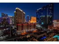 Striking night view of the Las Vegas skyline featuring multiple hotels and buildings at 135 E Harmon Ave # 1007, Las Vegas, NV 89109