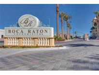 Boca Raton Condominiums sign and gated entry with brick-paved drive and palm trees on a bright day at 2455 W Serene Ave # 603, Las Vegas, NV 89123