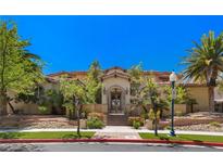 Elegant home featuring detailed wrought iron entry gate and manicured landscaping, offering luxurious curb appeal at 2600 Cervino Cir, Henderson, NV 89052