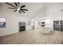 Bright living space featuring a fireplace, ceiling fan, and updated kitchen with stainless appliances at 2925 Wigwam Pkwy # 923, Henderson, NV 89074