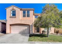 Inviting two-story home features a two car garage, mature landscaping, and classic architecture at 3008 Hot Cider Ave, North Las Vegas, NV 89031