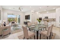 Bright living room featuring a glass dining table, modern furnishings, and access to the outdoor patio at 354 Spotted Dove St, Las Vegas, NV 89138