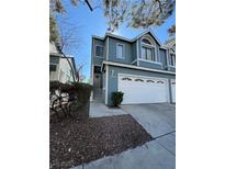 Inviting two-story townhome with a well-maintained front yard and attached two car garage at 4923 Strauss Dr, Las Vegas, NV 89146