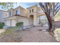 Charming two-story home with a red tile roof and a spacious two-car garage, surrounded by desert landscaping at 501 Tuscany View St, Las Vegas, NV 89145