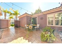 Charming patio with stamped concrete, outdoor seating and string lights at 8209 Chapelle Ct, Las Vegas, NV 89131