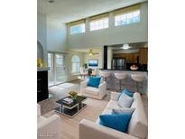 Bright open living room featuring a modern kitchen with stainless steel appliances and bar seating at 9325 W Desert Inn Rd # 218, Las Vegas, NV 89117