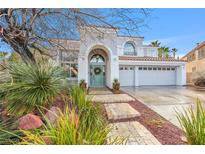 Charming two-story home featuring a three car garage and mature landscaping at 1700 Monte Rio Ct, Las Vegas, NV 89128