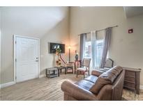 Comfortable living room featuring wood floors, neutral walls, and a contemporary design at 10431 Kitty Joyce Ave, Las Vegas, NV 89129