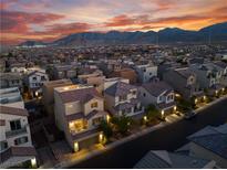 Desert community home featuring mountain views, tile roofs, and well-maintained streets at sunset at 10725 Wrigley Field Ave, Las Vegas, NV 89166