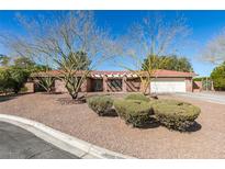 Charming single-story brick home featuring desert landscaping and a red tile roof, perfect for low-maintenance living at 2246 Almart Cir, Henderson, NV 89014