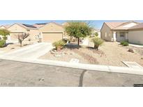 Charming single-story home featuring desert landscaping for low-maintenance appeal at 2404 Garganey Ave, North Las Vegas, NV 89084