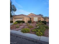 Charming single-story home featuring a two car garage and meticulously landscaped front yard at 2467 Moonlight Valley Ave, Henderson, NV 89044