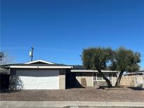 Charming single-story home featuring a well-maintained front yard and an attached two-car garage at 4504 Cinderella Ln, Las Vegas, NV 89102