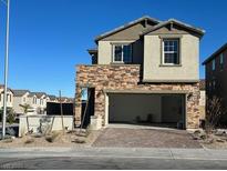 Modern two-story home with stone accents, a spacious two-car garage, and desert landscaping at 4540 Anspach St, North Las Vegas, NV 89031